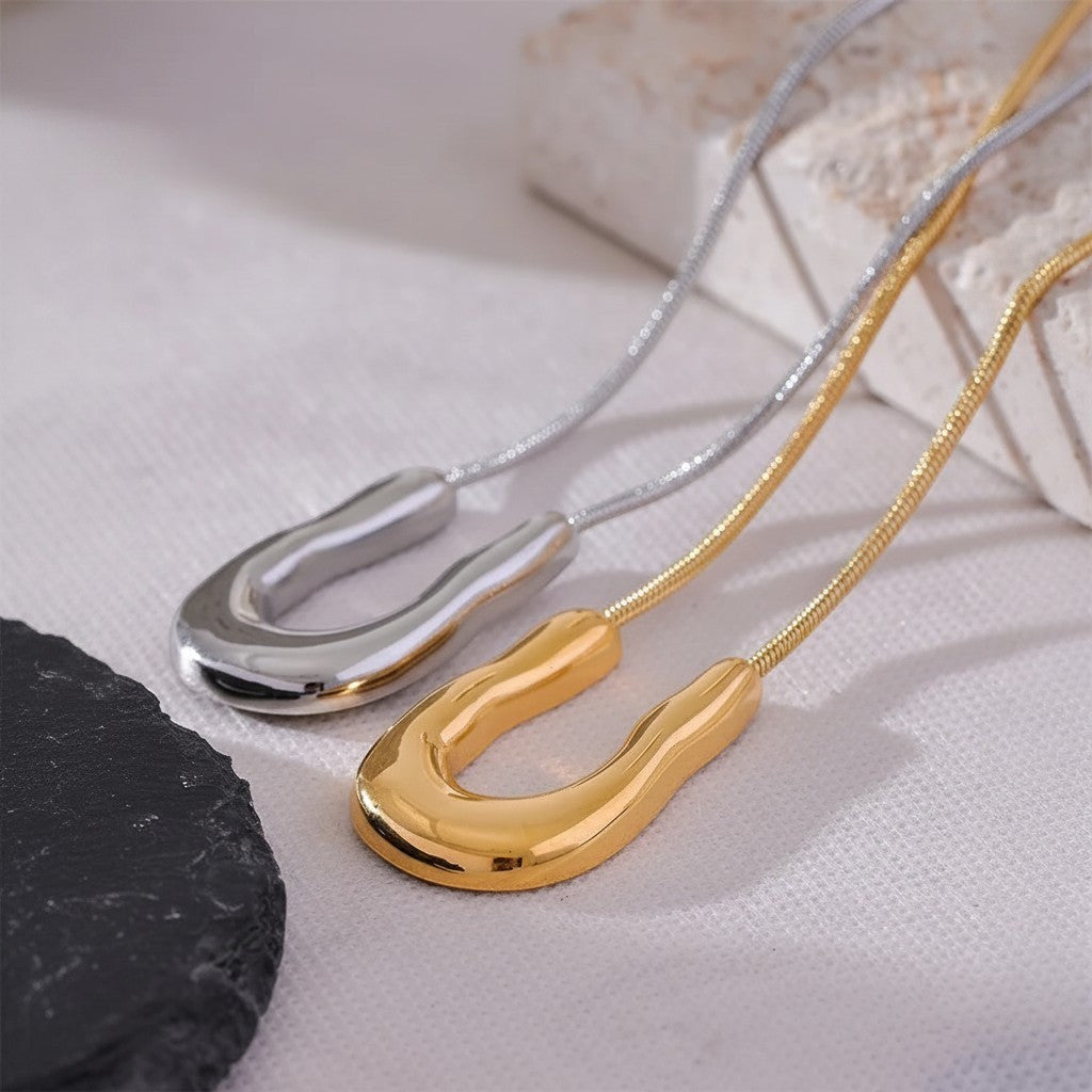 PRO RAY ELORA necklace with sculptural gold and silver organic pendant on snake chains.