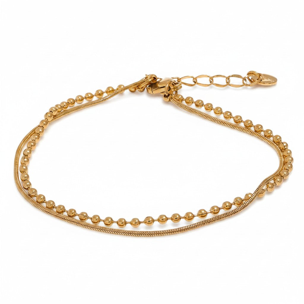 PRO RAY gold layered bracelet with fine bead detailing and fluid snake chain. Minimalist design.