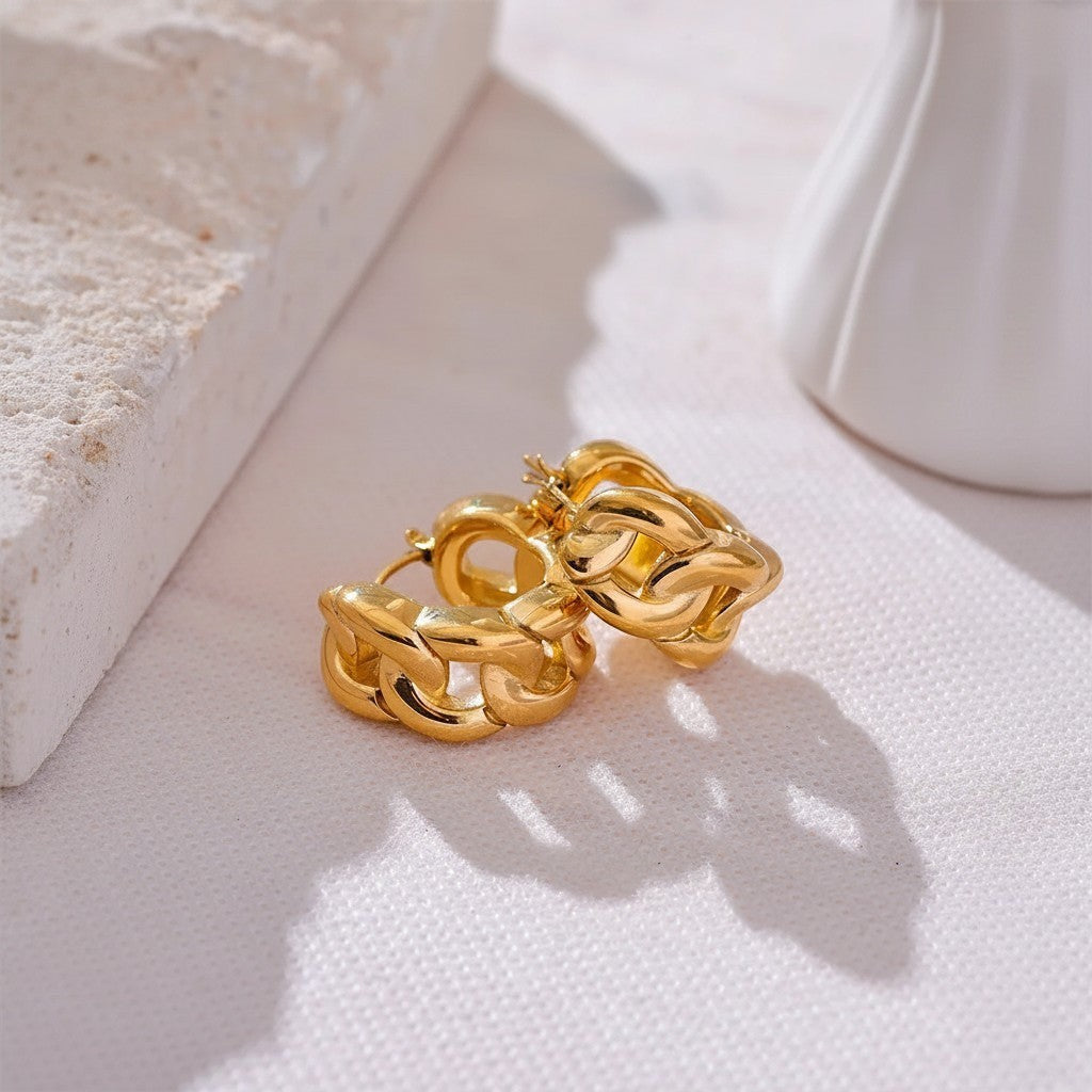 PRO RAY chunky gold chain-inspired hoop earrings with a sculptural design. Modern statement jewelry.