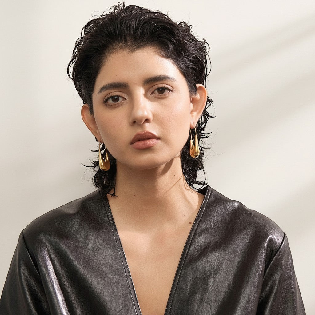 PRO RAY NYRA Hoops sculptural drop earrings in polished gold finish, elongated silhouette, 48mm length.