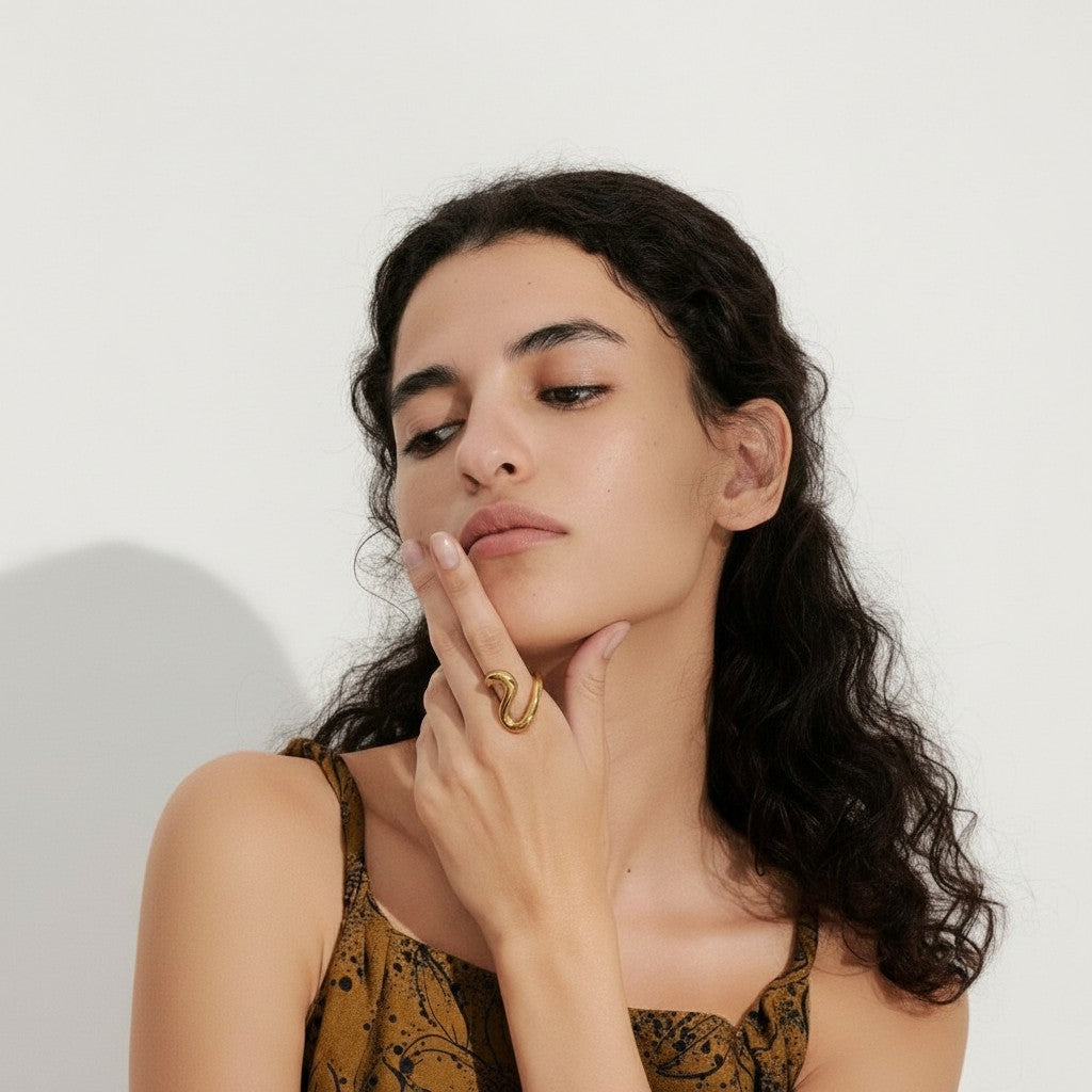 PRO RAY SORELLE sculptural open ring with fluid curved lines in gold-tone metal.