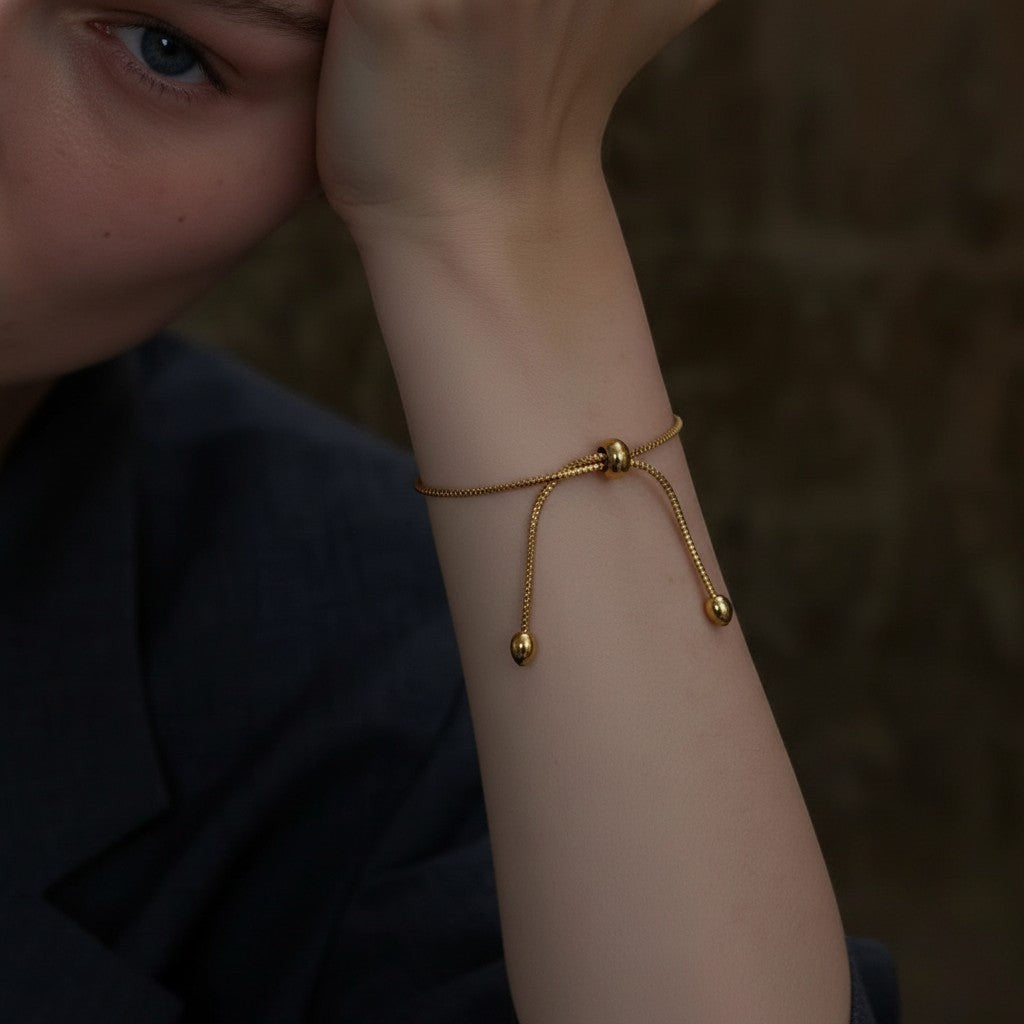 PRO RAY ZARELIA gold snake chain bracelet with adjustable closure and bead detail on a model.