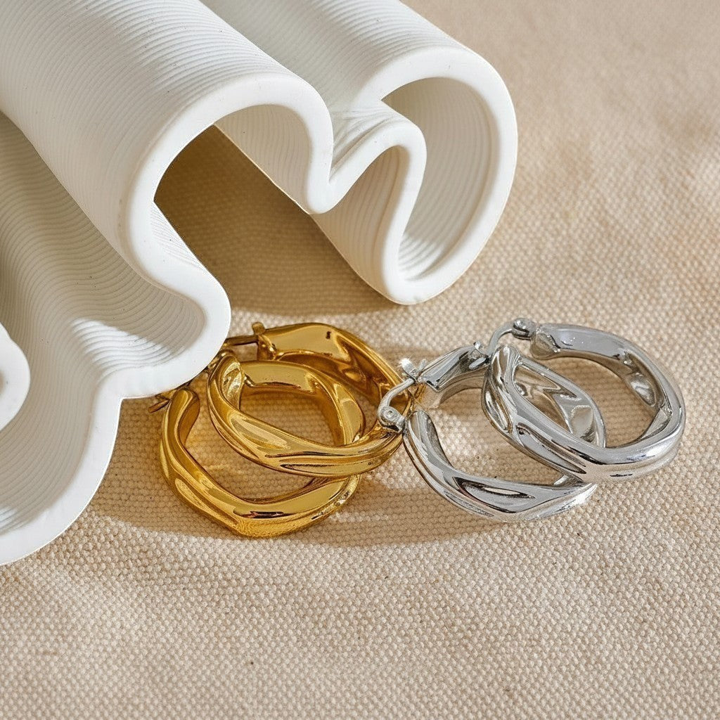 PRO RAY ZARIA gold and silver twisted hoop earrings with sculptural silhouette, 31mm diameter.