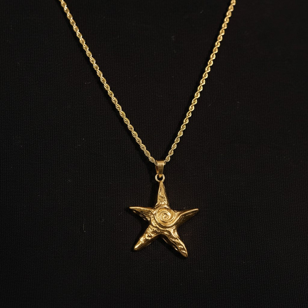 PRO RAY ZOREYA gold star pendant necklace with sculptural detailing on a rope chain.