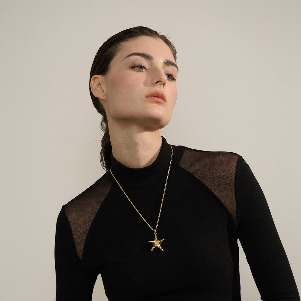 PRO RAY ZOREYA gold star pendant necklace with sculptural detailing on a fine chain.